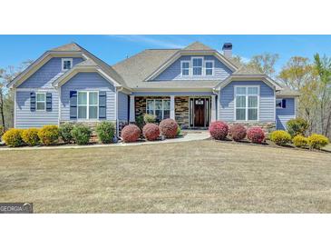 Charming home with a stone and siding facade, landscaped front yard, and covered front porch at 270 Blue Point Pkwy, Fayetteville, GA 30215