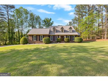 Charming brick home with well-manicured lawn and mature landscaping in a peaceful, established neighborhood at 105 Hartford Pl, Fayetteville, GA 30214