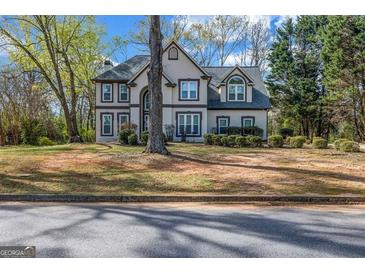 Charming two-story home with neutral siding, trimmed windows, mature landscaping, and a classic architectural style at 3139 Players Dr, Jonesboro, GA 30236