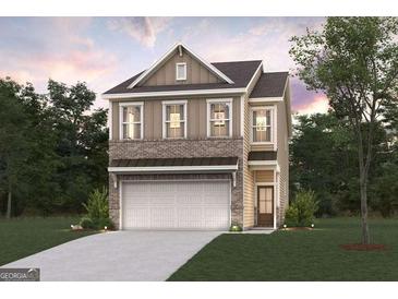 Charming two-story home featuring a brick and siding exterior, a two-car garage, and a well-manicured lawn at 1028 Sutherland Lane # 45, Lawrenceville, GA 30043
