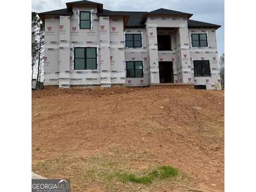 New construction home featuring black trim windows and house wrap ready for the next phase at 421 Saint Surrey Way, Ellenwood, GA 30294
