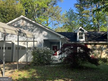 Charming single-story home with a covered carport, stone accents, and well-maintained landscaping at 1499 Carriage Ln, Jonesboro, GA 30238