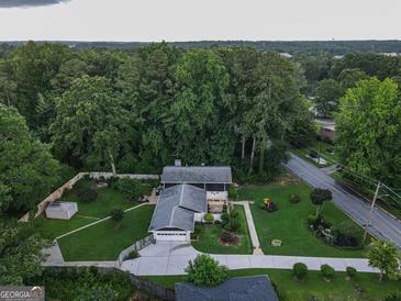 Expansive aerial view of landscaped property featuring a well-maintained yard and mature trees at 4213 Janice Drive, Atlanta, GA 30337