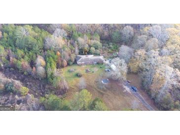 A sprawling property surrounded by lush greenery, offering privacy and seclusion at 98 Almon Church Rd, Covington, GA 30014