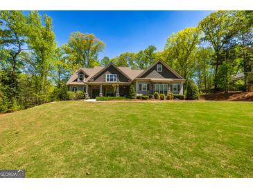 Charming home featuring lush landscaping and a well-manicured lawn at 410 Wicklow St, Tyrone, GA 30290