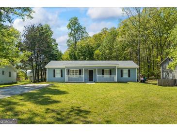 Charming single-story home with a well-maintained lawn and inviting front porch at 195 Riverbend Dr, Covington, GA 30014