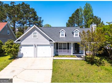Charming one-story home featuring a two-car garage and well-maintained front yard at 6844 Saganaw Dr, Rex, GA 30273