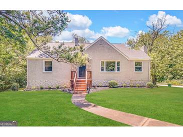 Charming single-Gathering home featuring a well-maintained lawn and inviting front entrance with stone accents at 2361 Whites Mill Rd, Decatur, GA 30032