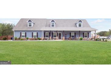Charming, blue single-story home with a spacious front yard and welcoming front porch at 155 Lawrence Dr, Villa Rica, GA 30180