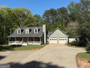 Charming home featuring a welcoming front porch and a convenient two-car garage at 4430 Kings Hwy, Douglasville, GA 30135
