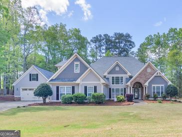 Charming two-story home featuring a well-manicured lawn and craftsman-style details at 225 Suffolk Way, Mcdonough, GA 30252