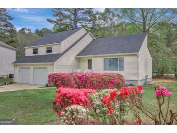 Charming two-story home with a well-manicured lawn and colorful azalea bushes at 106 Gateway Pt, Peachtree City, GA 30269