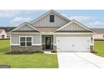 Charming single-Gathering home boasts neutral siding, a two-car garage, and inviting curb appeal at 1033 Claas Way, Locust Grove, GA 30248