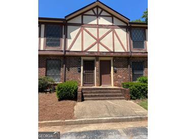 Charming two-story townhome with brick facade, front steps, and well-maintained landscaping at 3244 Abbeywood Dr, Decatur, GA 30034