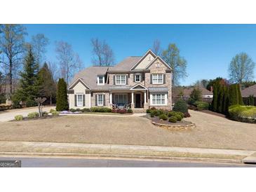 Charming brick and stone two-story home with a well-manicured lawn and inviting front porch at 2358 New Salem Trce, Marietta, GA 30064