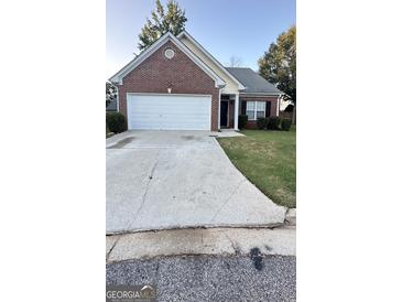 Cozy brick home featuring an attached two-car garage and well-maintained front yard at 4194 Wesley Hall Ln, Decatur, GA 30035