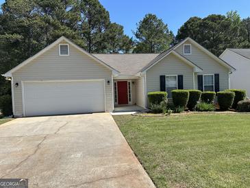 Charming single Gathering home featuring a well maintained yard and two-car garage at 12214 Cypress Way, Fayetteville, GA 30215