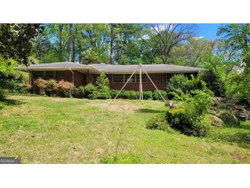 A single-story brick home with an expansive front yard at 1198 Lynhurst Sw Dr, Atlanta, GA 30311