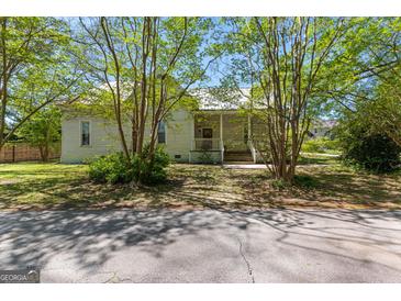 Charming house with trees, classic architectural details, and a welcoming front porch at 2354 Hamilton St, Hampton, GA 30228