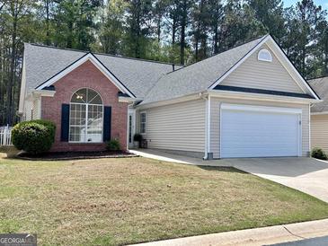 Charming single-story home with a brick facade, attached garage, and well-maintained lawn at 403 Rock Creek Dr, Peachtree City, GA 30269