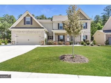 Charming two-story home with a brick facade, two-car garage, and well-maintained lawn at 1700 Cobblefield Cir, Dacula, GA 30019