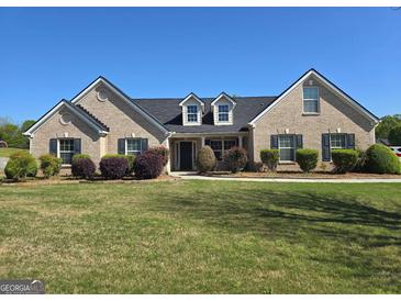 Charming brick home with a well-maintained lawn and mature landscaping at 35 Charleston Ln, Covington, GA 30016