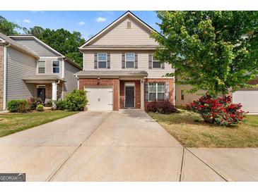 Charming two-story home featuring a brick facade, well-maintained landscaping, and a single-car garage at 11755 Lovejoy Crossing Blvd, Hampton, GA 30228