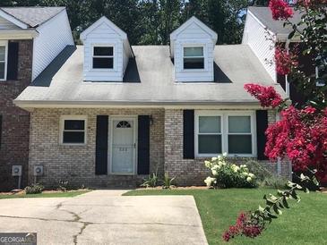 Charming brick home featuring a well-maintained lawn and lovely landscaping at 222 Flat Creek Ct, Peachtree City, GA 30269