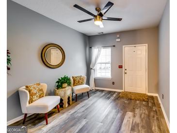 Inviting living room boasts stylish decor, ceiling fan, and neutral wall colors at 7750 Carnegie Dr, Fairburn, GA 30213