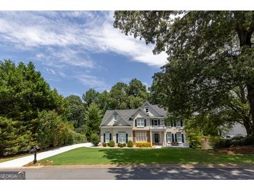 Charming two-story home with a manicured lawn and well-maintained landscaping, creating a welcoming curb appeal at 6205 Collingham Trce, Cumming, GA 30040