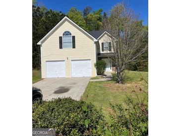 Inviting two-story home features a two-car garage and manicured front yard at 5041 Cottage Grove Pl, Union City, GA 30291