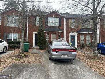 Charming brick townhome featuring a private driveway and cozy curb appeal at 2698 Norfair Loop, Lithonia, GA 30038