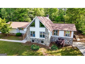 Charming home featuring stone accents, a gable roof, and well-maintained landscaping at 3222 Bay View Dr, Jonesboro, GA 30236