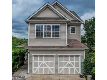 Two-story home featuring a two-car garage and a charming exterior design with large windows at 2681 Mariner Way, Villa Rica, GA 30180