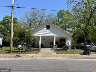 Charming one-story home featuring a covered porch with classic columns and a well-maintained front yard at 3143 S West St, Covington, GA 30014