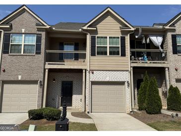 Charming townhome with a private balcony, attached garages, and well-maintained landscaping at 1853 Broad River Rd, Atlanta, GA 30349