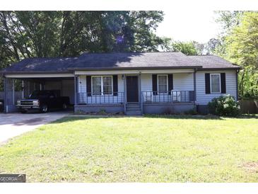 Charming single-story home featuring a carport, front porch, and a well-manicured lawn at 4793 Davenport Nw Trce, Acworth, GA 30101