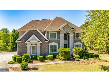 Beautiful two-story brick home with manicured landscaping and a well-maintained front lawn at 325 Elderberry Trl, Fayetteville, GA 30214