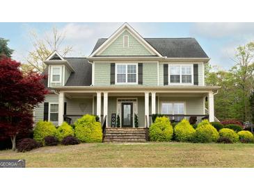 Charming two-story home featuring a welcoming front porch, landscaped yard, and classic architectural details at 109 Lighthorse Blvd, Mcdonough, GA 30252