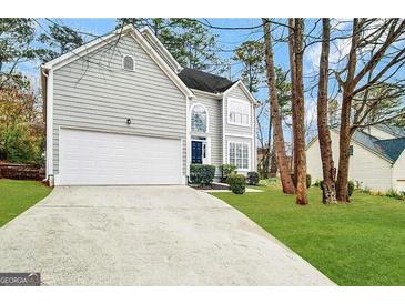 Charming two-story home with a well-manicured lawn, two car garage, and inviting curb appeal at 2578 Lavender Ct, Decatur, GA 30034