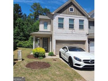 Charming brick townhome with a well-manicured lawn and attached garage at 3168 Spicy Cedar Ln, Lithonia, GA 30038