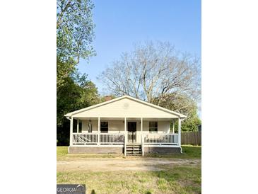 Charming single story home with a covered porch and beautiful trees in the front yard at 11755 Highway 36, Covington, GA 30014