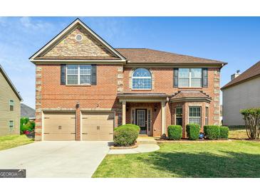 Charming two-story brick home with attached two-car garage and well-manicured lawn at 532 Pelham Pl, Mcdonough, GA 30253
