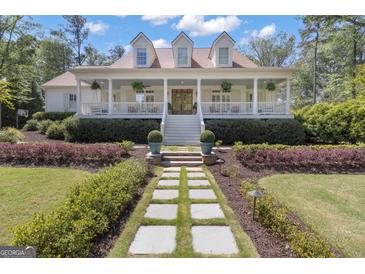 Inviting two-story home with a charming front porch and beautiful landscaped walkway at 105 Suffolk Pl, Fayetteville, GA 30215