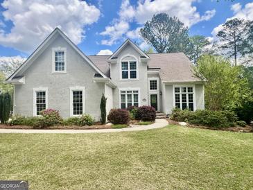 Stunning two-story home featuring a well-manicured lawn and charming landscaping at 110 Cadmium Ct, Peachtree City, GA 30269