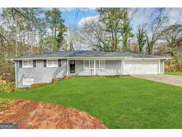 Charming one-story home featuring a well-manicured lawn and classic brick exterior, perfect for comfortable suburban living at 668 Fielding Sw Ln, Atlanta, GA 30311