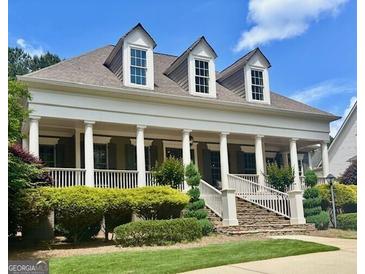 Charming traditional home featuring a welcoming front porch, well-manicured lawn, and classic architectural details at 100 Trotters Rdg, Fayetteville, GA 30215