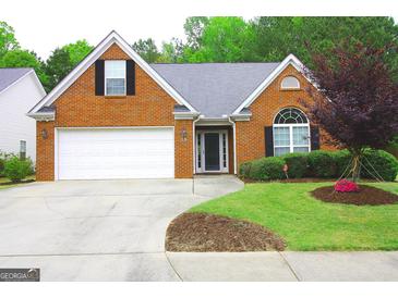 Charming single-Gathering home with a well-manicured lawn, brick facade, and two car garage at 25 Pacific Ave, Sharpsburg, GA 30277
