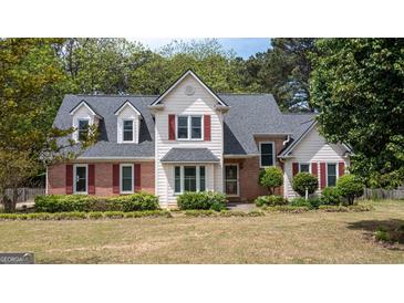 Charming two-story home with red shutters, brick accents and meticulously landscaped front yard at 250 Clearview Cir, Mcdonough, GA 30253