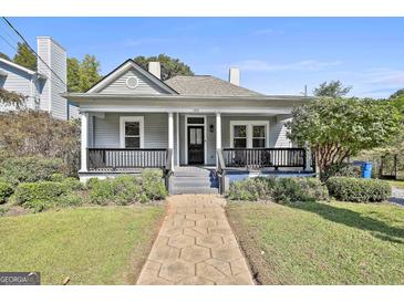 Charming home with a covered front porch, landscaped yard, and inviting walkway at 1449 Wadley Ave, East Point, GA 30344